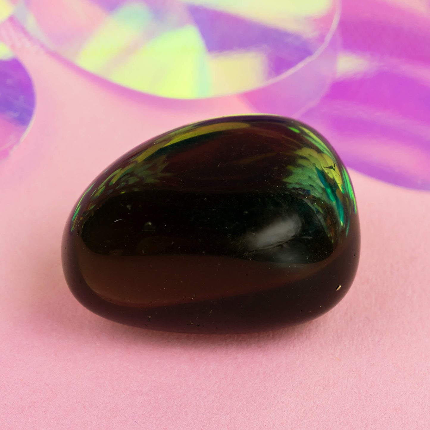 Happiness Enchanters smokey obsidian crystal on a pink holographic backdrop