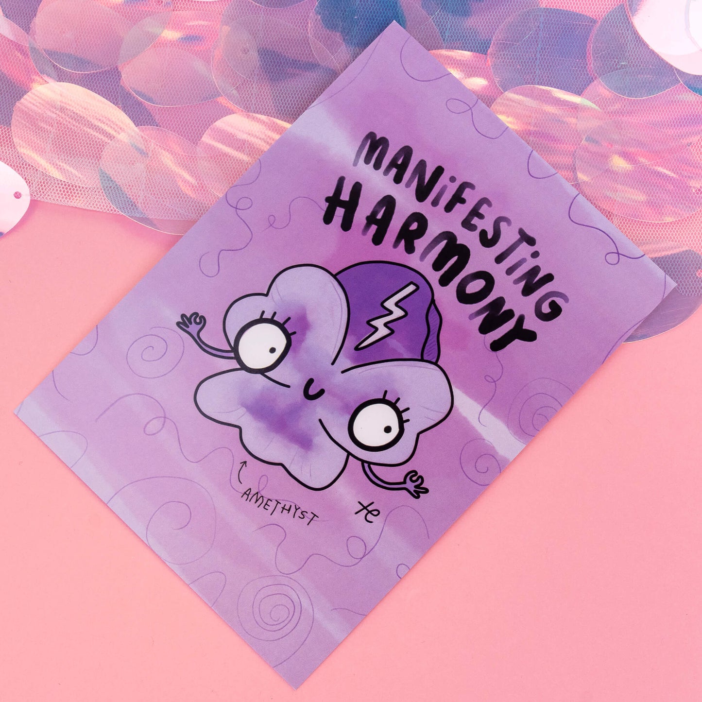 A close-up view of an Amethyst-themed postcard by 'Happiness Enchanters', displaying a charming cartoon Amethyst crystal with the phrase 'Manifesting Harmony'. The background is a vibrant purple with swirling patterns, capturing the essence of creativity and enchantment.