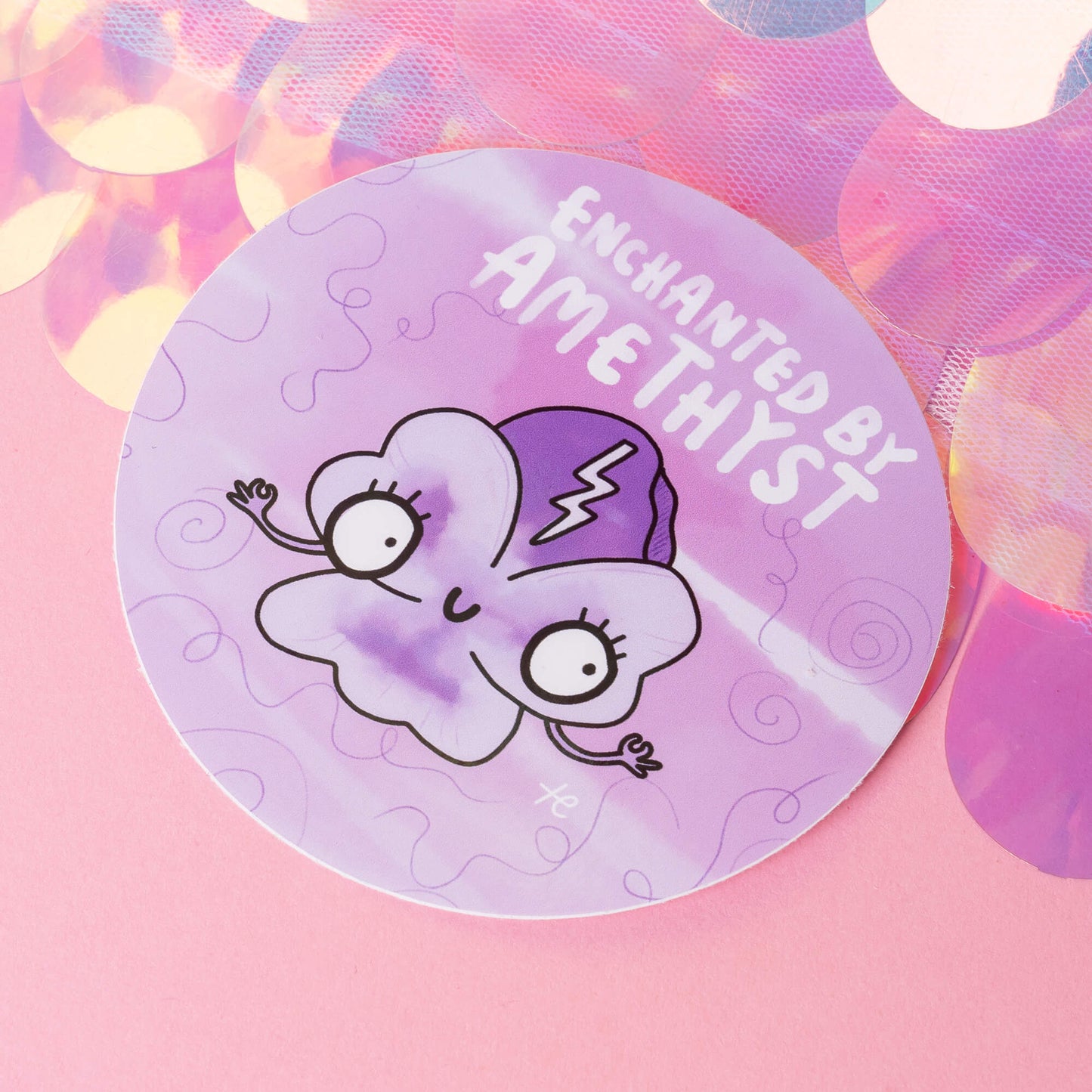 Happiness Enchanters' 'Enchanted by Amethyst' sticker featuring a whimsical cartoon amethyst character with a purple hat and a lightning bolt, set against a dreamy, lavender background. The illustration embodies the brand's playful, magical aesthetic, emphasising creativity and transformation.