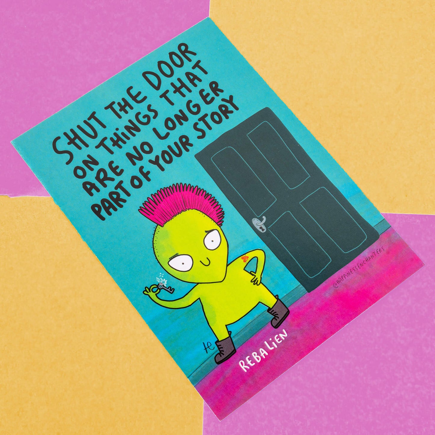 An illustrated card from Happiness Enchanters featuring a vibrant green alien character with a pink mohawk holding a key. The character stands confidently in front of a dark door with the text "Shut the door on things that are no longer part of your story" above. The card is against a colourful background with yellow, pink, and purple segments.