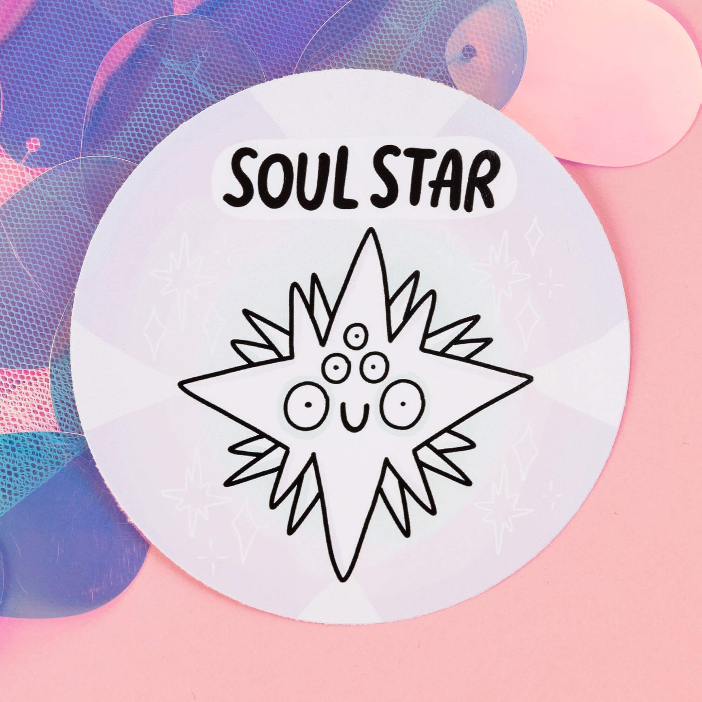 Soul star Chakreatures sticker by Happiness Enchanters. A circular sticker with a white diamond shaped creature illustrated by Katie Abey with multiple eyes and smiling mouth on a white background. 'Soul Star' is written above the character. The sticker is sat on a pink backdrop.
