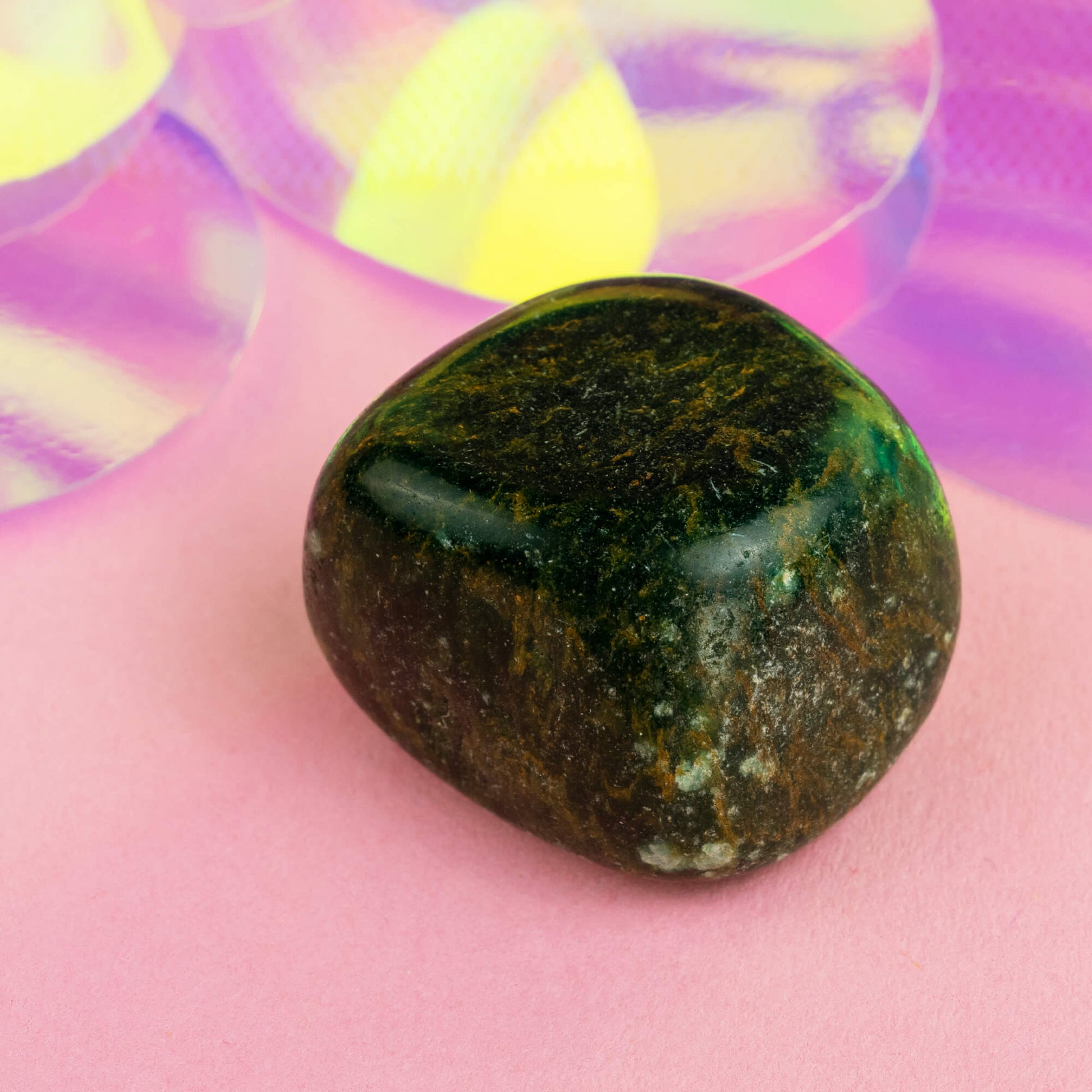 Happiness Enchanters nephrite jade crystal on a pink holographic backdrop