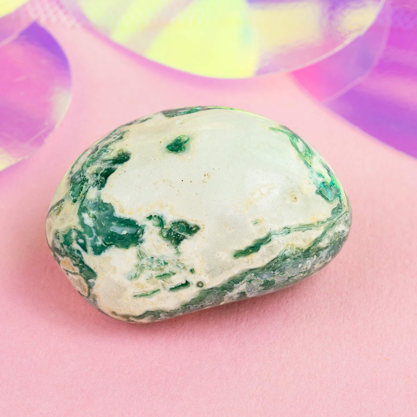 Happiness Enchanters tree agate crystal on a pink holographic backdrop