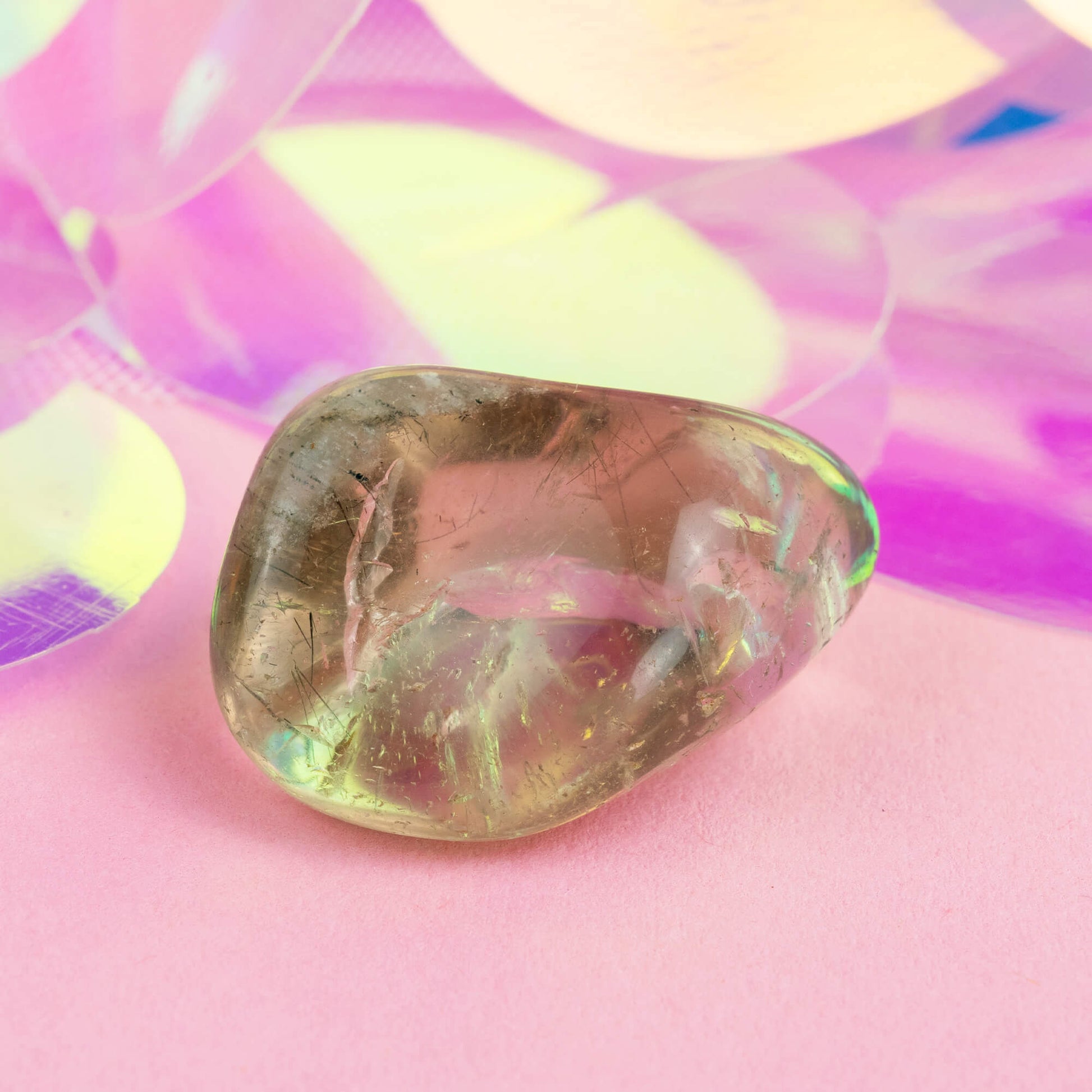 Happiness Enchanters smokey quartz crystal on a pink holographic backdrop