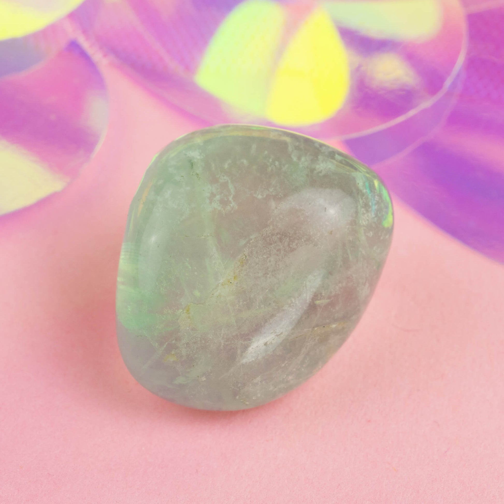 Happiness Enchanters Fluorite crystal on a pink holographic backdrop