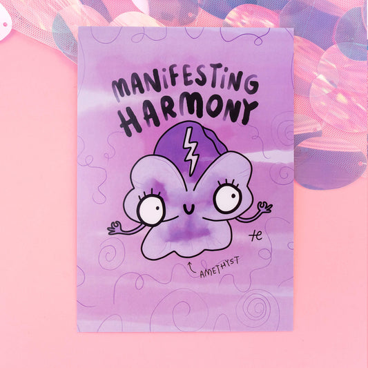 A whimsical Amethyst-themed postcard from 'Happiness Enchanters', showcasing a cute, cartoon Amethyst crystal character with the text 'Manifesting Harmony' on a purple, swirly-patterned background. The postcard radiates a magical and playful essence.