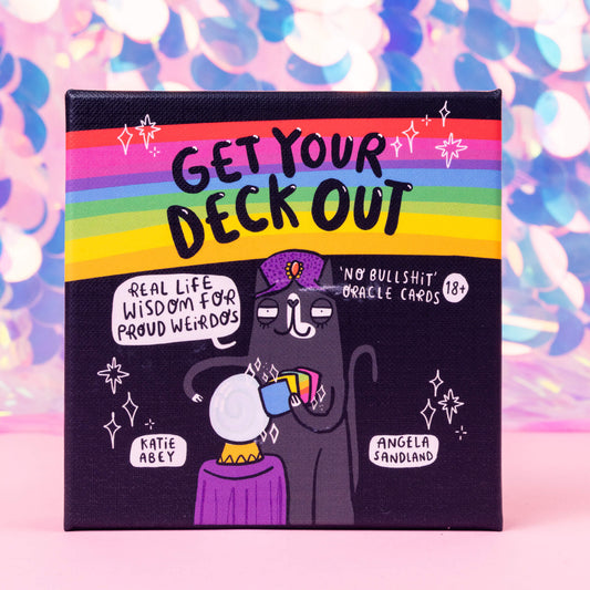 Happiness Enchanters Get Your Deck Out, feel-good deck of 50 rainbow oracle cards. Black box featured an illustrated black cat with tarot cards and crystal ball, black writing on rainbow with stars and letters that read 'real life wisdom for proud weirdos' and 'no *swear word* oracle cards' 18+. Designed and printed in the UK by Katie Abey and Angela Sandland.