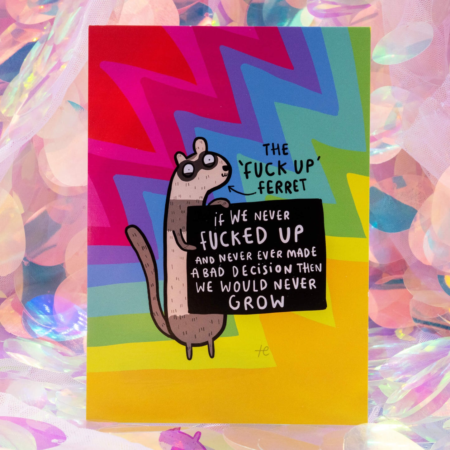 The ‘Fuck Up’ Ferret Postcard by Happiness Enchanters, shown against a pastel iridescent background. The cheerful rainbow design features an illustrated ferret spreading a message of self-growth and acceptance.