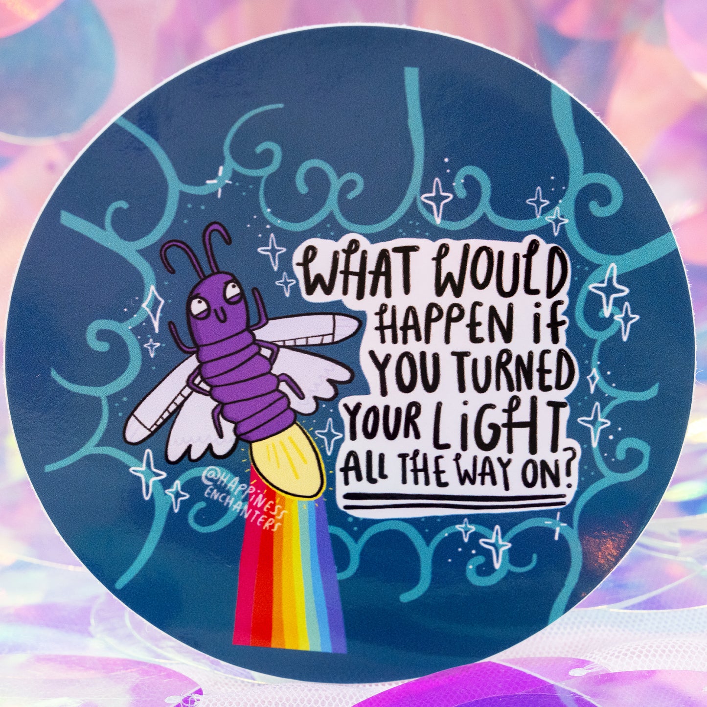 Close-up of the Turned Your Light All The Way On Sticker by Happiness Enchanters. The round design shows a cheerful purple firefly with a glowing light and rainbow trail beside the quote “What would happen if you turned your light all the way on?”. Decorative teal swirls, sparkles and a soft iridescent backdrop create a whimsical, uplifting feel.