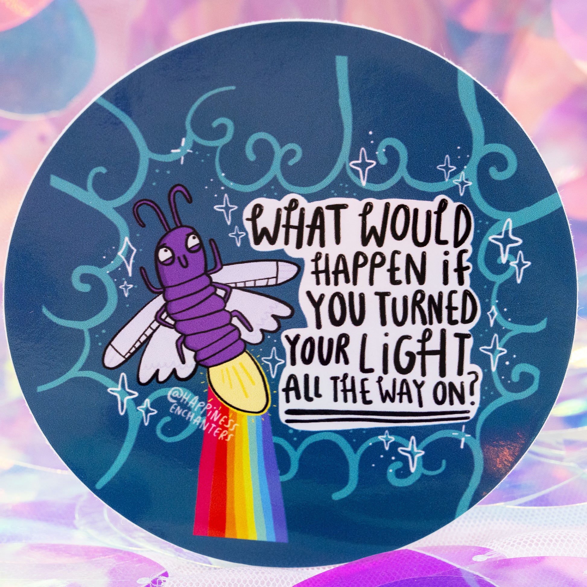 Close-up of the Turned Your Light All The Way On Sticker by Happiness Enchanters. The round design shows a cheerful purple firefly with a glowing light and rainbow trail beside the quote “What would happen if you turned your light all the way on?”. Decorative teal swirls, sparkles and a soft iridescent backdrop create a whimsical, uplifting feel.