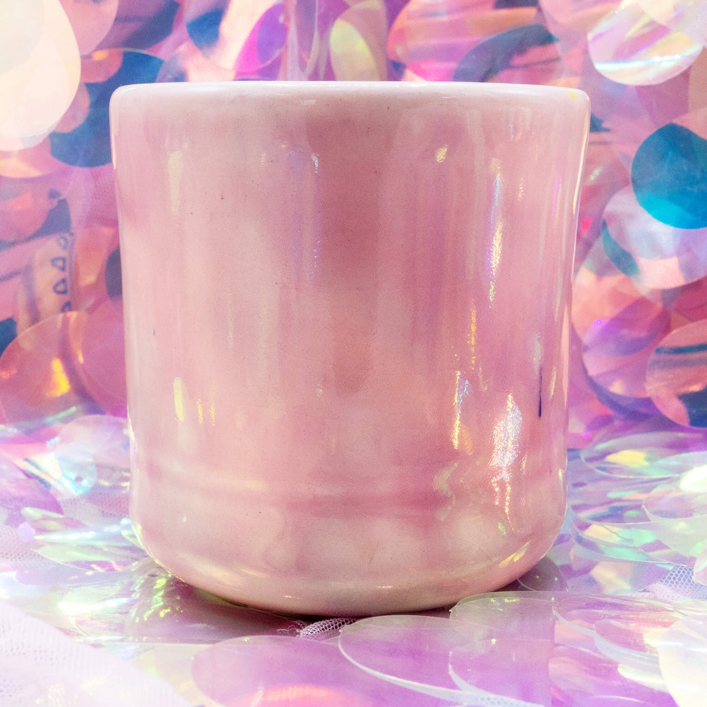 Back of the pale pink Happiness Enchanters cacao mug with glossy glaze finish.
