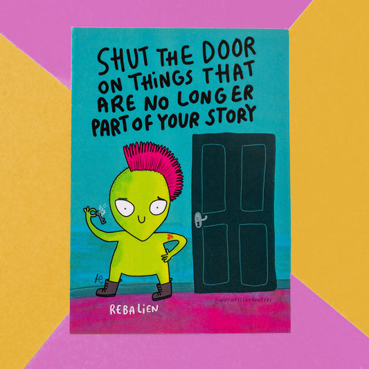 A colourful greeting card by Happiness Enchanters featuring a playful green alien with a pink mohawk holding a key. The character stands next to a closed door with the message "Shut the door on things that are no longer part of your story" in bold black text. The card's background is segmented into bright colours including yellow and pink.