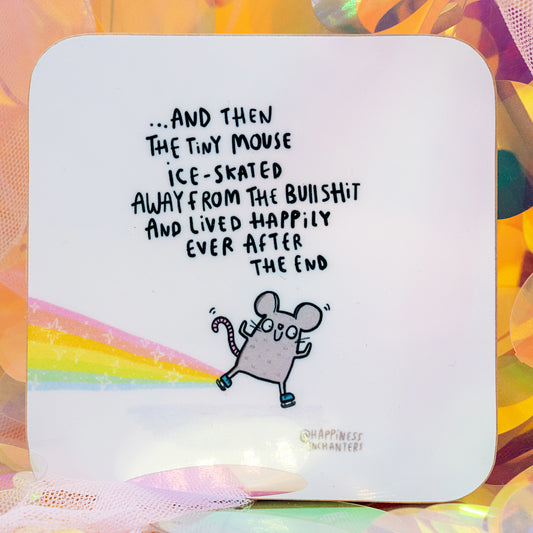 Happily Ever After Tiny Mouse Coaster by Happiness Enchanters, showcasing a whimsical illustrated mouse skating along a rainbow with uplifting sweary text about escaping the nonsense and living happily ever after. Shown against a dreamy pastel iridescent backdrop. Designed by Katie Abey and Angela Sandland.