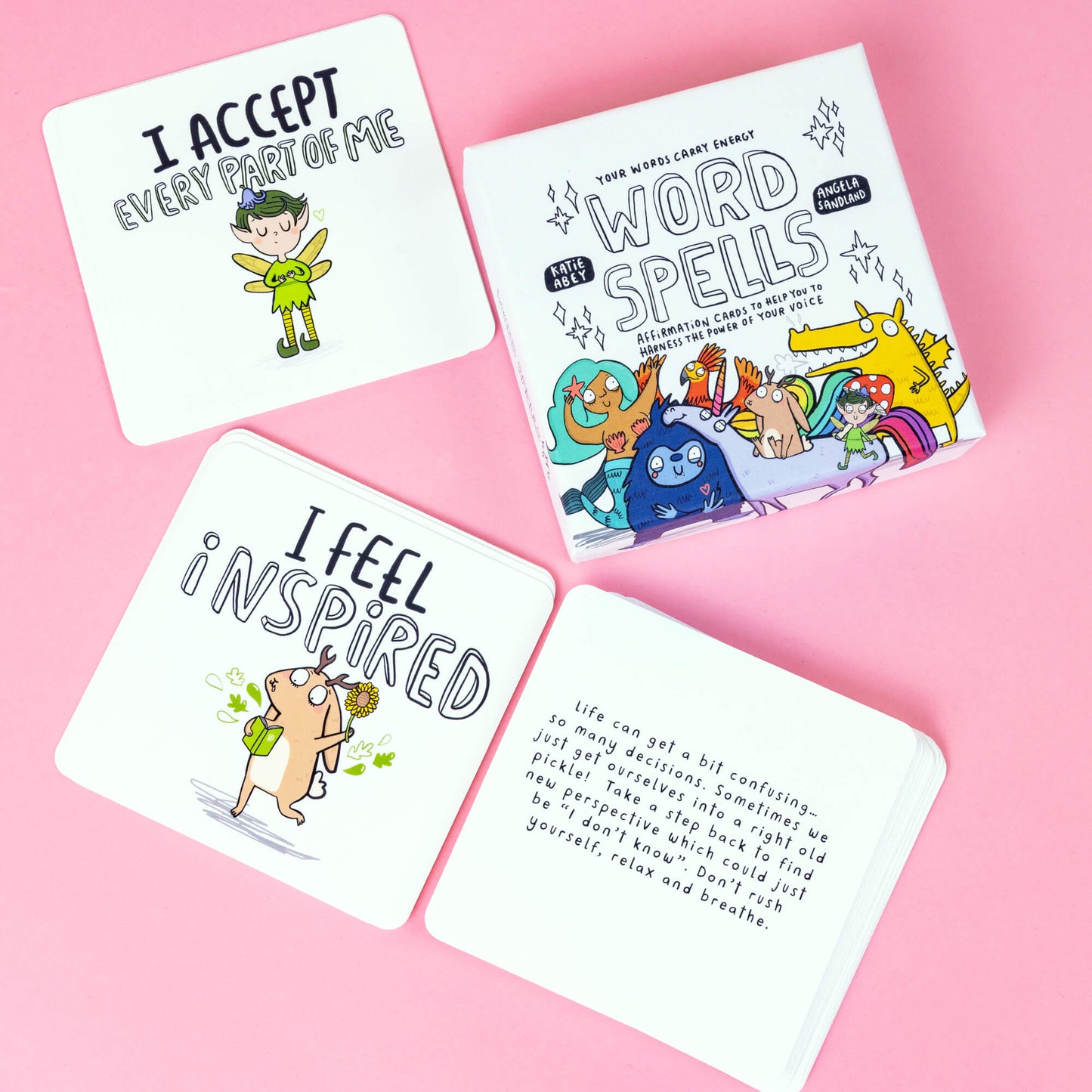 Box of Word Spell Cards on a pink and sparkly background, the box is white with 'your words carry energy' and 'affirmation cards to help you to harness the power of your voice' written on with various illustrations.