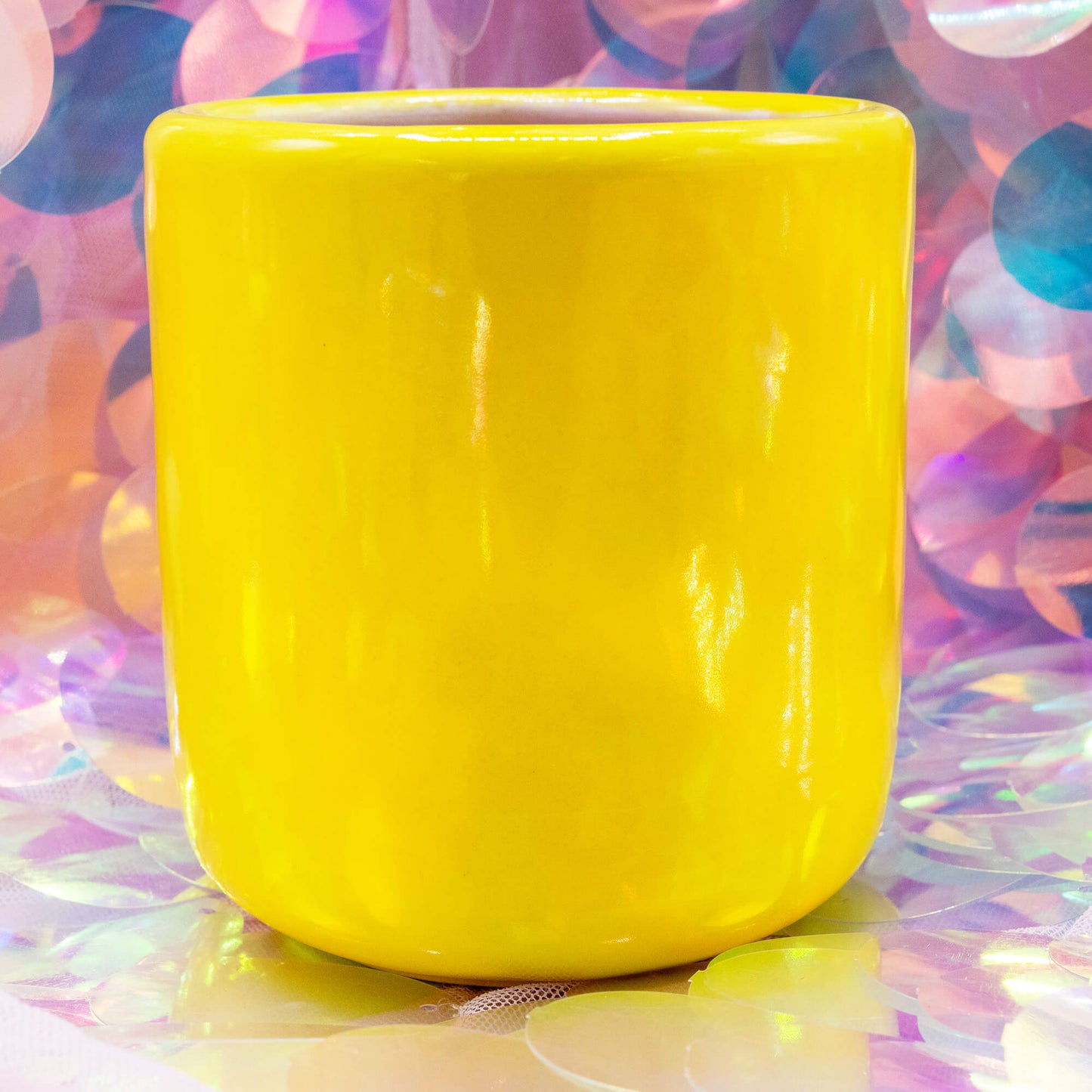 Back view of the yellow Happiness Enchanters cacao cup with smooth glossy glaze.